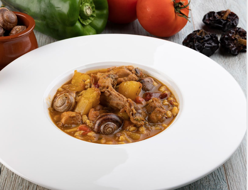 Ensalada variada de brotes tiernos con tomate y gurullos con conejo y caracoles